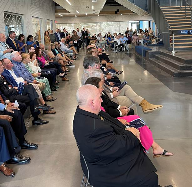 Community members and distinguished guests fill the lobby of the new Advanced Manufacturing Training Facility