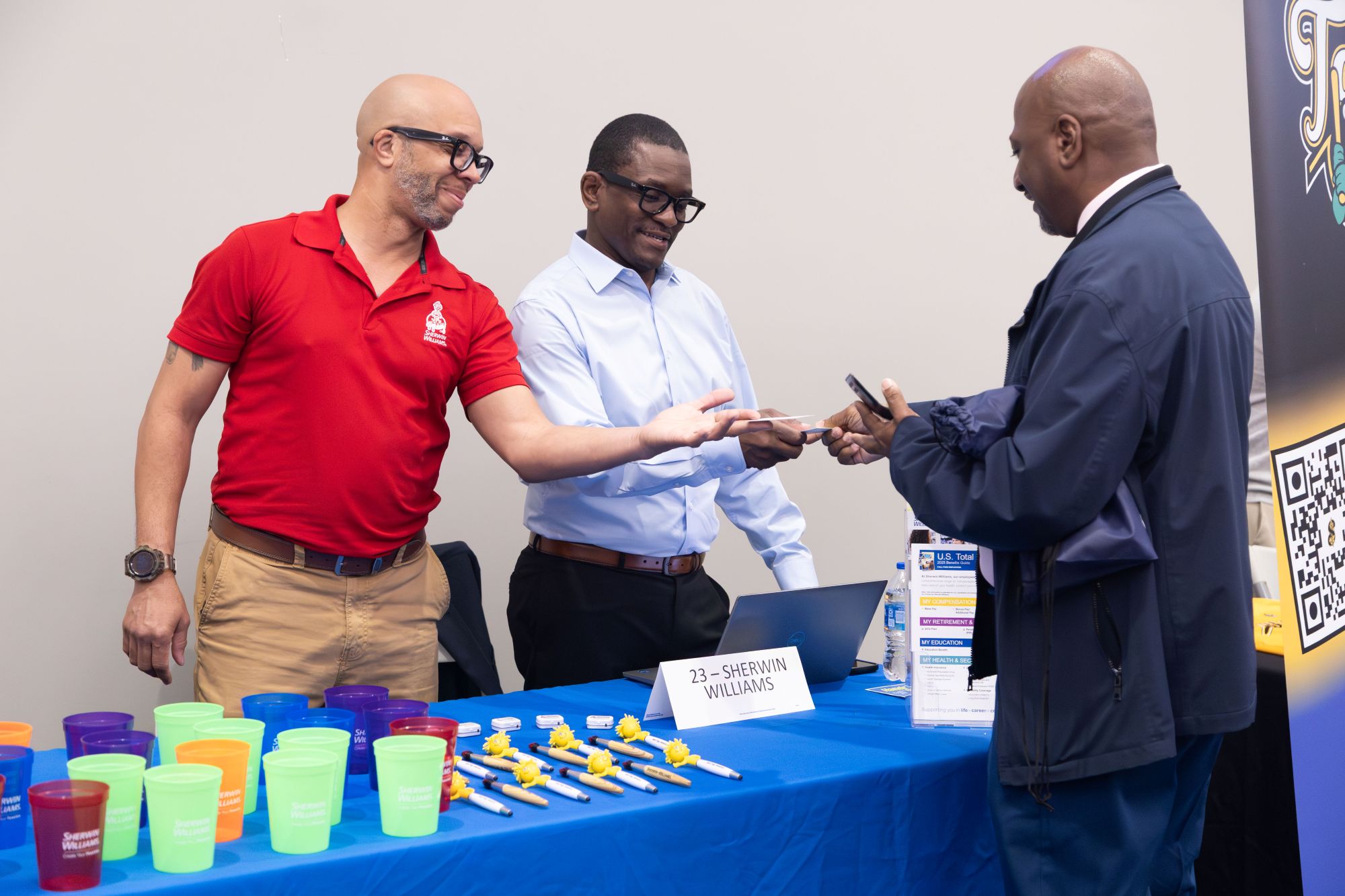 Employees handing man business cards for their organization