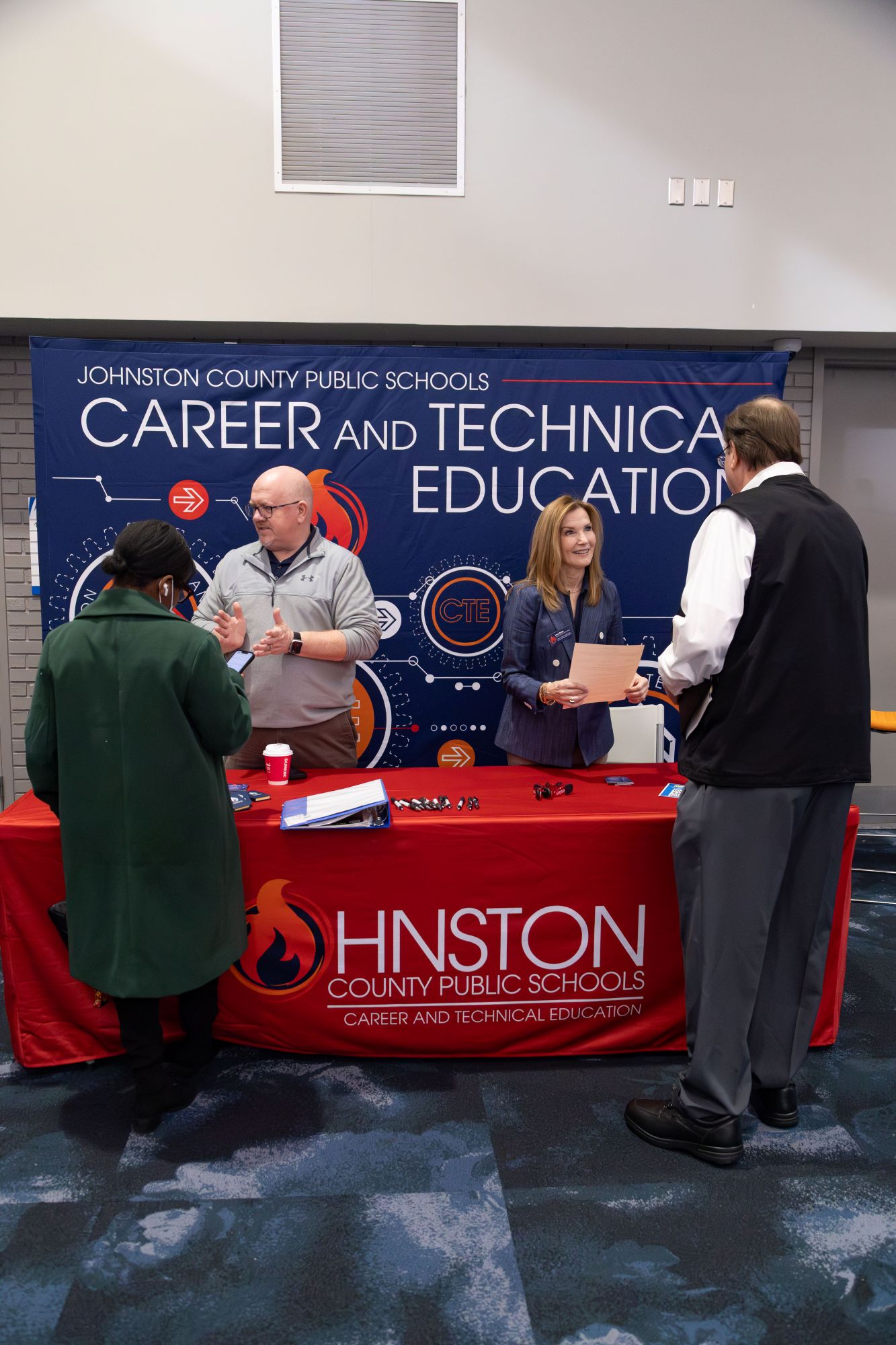 jcps employees talk to interested people at the job fair