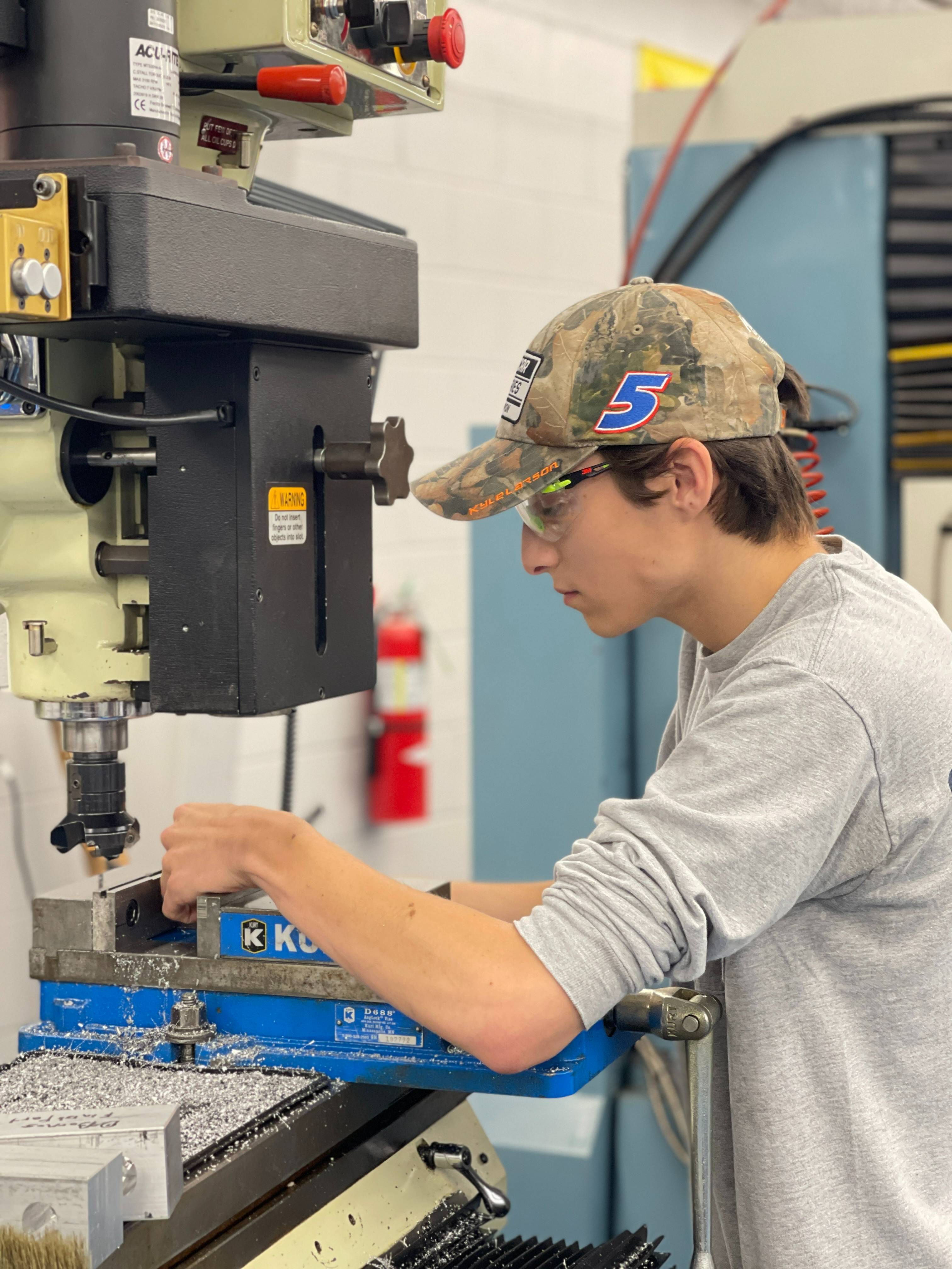 Student using press in lab